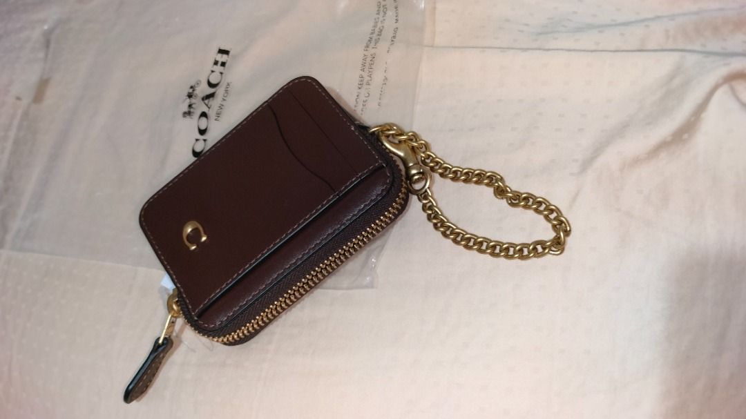 Coach Card Case with Chain (Category: Luxury Bags & Wallets) located in Quezon City. Submitted by amdina03 (Listing ID 1428242966, Image 2). Description: Coach zip card case leather (money back guarantee authentic) If in doubt, please spare us the hassle and buy at the mall. leather with chain and zipper. Hard to find Maple. Includes a clear ID window and 2 card slots and 1 pocket. The zipper pull is embossed with "COACH NEW YORK". Made in the Ph