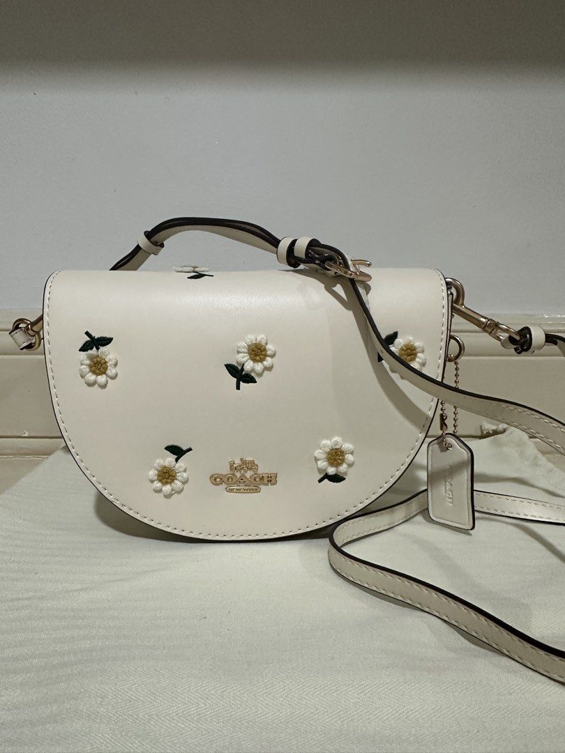 Coach Daisy Embroidered Crossbody Bag (Category: Luxury Bags & Wallets) located in Mandaue City. Submitted by decluttermama88 (Listing ID 1428237601, Image 2). Description: **Good Quality Super cute and feminine piece featuring embroidered daisy details on a soft cream leather base—perfect for everyday wear or adding a fresh touch to your outfit. Brand: Coach Color: Cream / Chalk Design: Daisy embroidery with gold-tone hardware Closure: Magnetic 