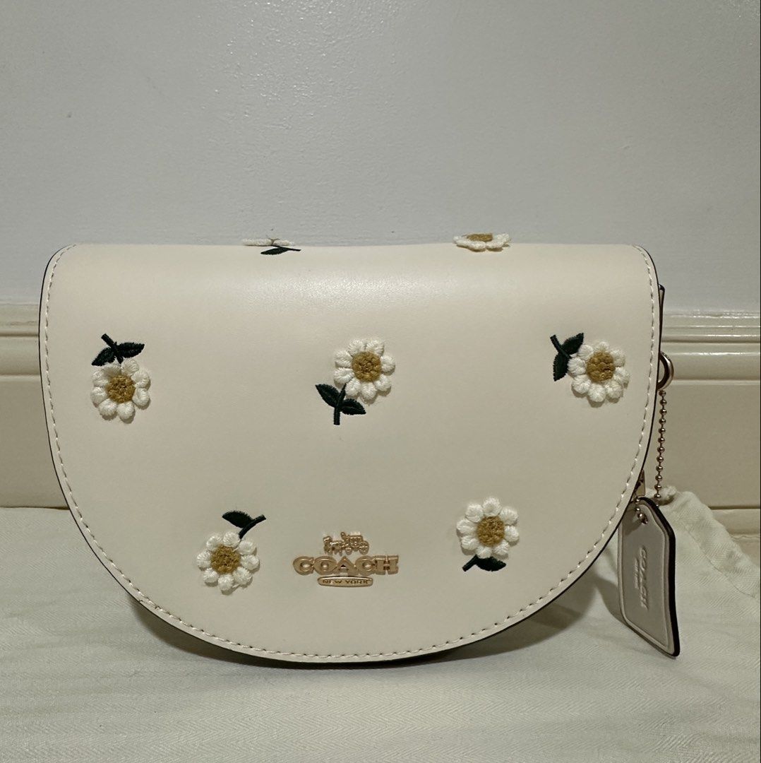 Coach Daisy Embroidered Crossbody Bag (Category: Luxury Bags & Wallets) located in Mandaue City. Submitted by decluttermama88 (Listing ID 1428237601, Image 1). Description: **Good Quality Super cute and feminine piece featuring embroidered daisy details on a soft cream leather base—perfect for everyday wear or adding a fresh touch to your outfit. Brand: Coach Color: Cream / Chalk Design: Daisy embroidery with gold-tone hardware Closure: Magnetic 
