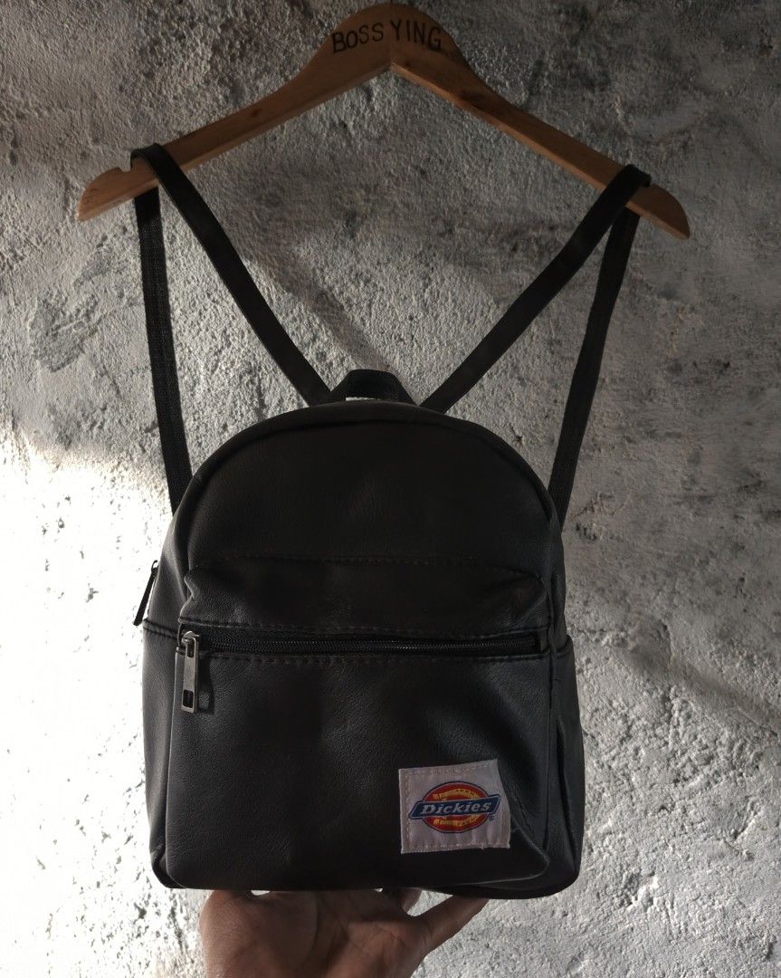 DICKIES | Men's Mini Backpack Black (Category: Backpacks) located in Naga. Submitted by bossyingthrifts (Listing ID 1428202240, Image 2). Description: DICKIES | Men's Mini Backpack Black Mini backpack features a black exterior with a front zippered pocket. It has adjustable shoulder straps and a top handle for carrying. The Dickies logo is prominently displayed on the front. Color rate: 9.5/10 Excellent Condition Issue: minimal rusty buckles, not