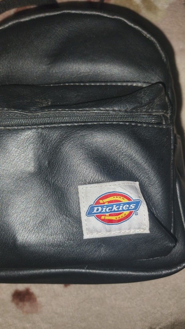 Dickies Mini Backpack (Category: Backpacks) located in Manila. Submitted by esteemed_shop (Listing ID 1428231034, Image 2). Description: Mini backpack features the Dickies logo on the front. It has a zippered main compartment and adjustable straps. It has a top handle for easy carrying..