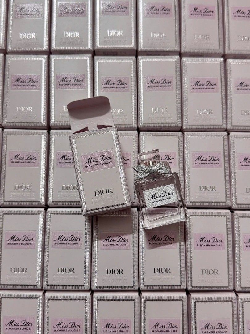 Dior Miss Dior Blooming Bouquet 5 ml (Category: Fragrance & Deodorants) located in Marikina City. Submitted by eudaimoniastudio (Listing ID 1428201859, Image 1). Description: Collection of Miss Dior Blooming Bouquet perfumes. The image shows multiple boxes of the perfume, along with a single bottle. The boxes are pink and have the Dior logo. The bottle has a bow on top. The perfume is a floral fragrance..