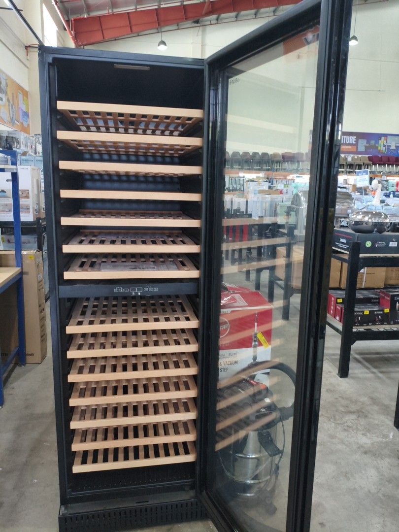 Euro Wine Cooler (Category: Food Organization & Storage) located in Manila. Submitted by hmrgrace5. (Listing ID 1428107256, Image 2). Description: Euro wine cooler with multiple wooden shelves. It has a glass door and a digital control panel. The original manual is included. The price tag shows the original price..