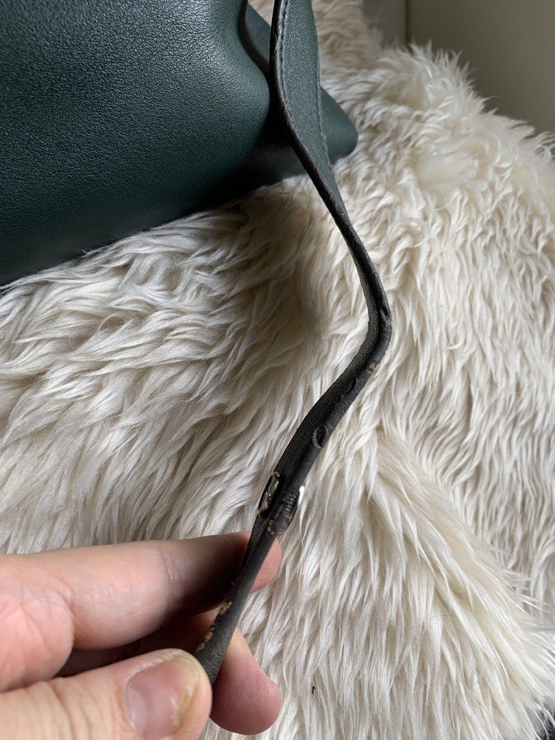 Fendi By The Way (Category: Luxury Bags & Wallets) located in Quezon City. Submitted by she-ann (Listing ID 1428234408, Image 3). Description: Authentic Green leather handbag from Fendi Roma. Features a top handle and a detachable shoulder strap. The bag has a silver zipper and studs. The Fendi Roma logo is visible on the front. No wholes sa corners. Normal signs of usage lang yung corners which can be recolored if you want Flaws: just the edge o