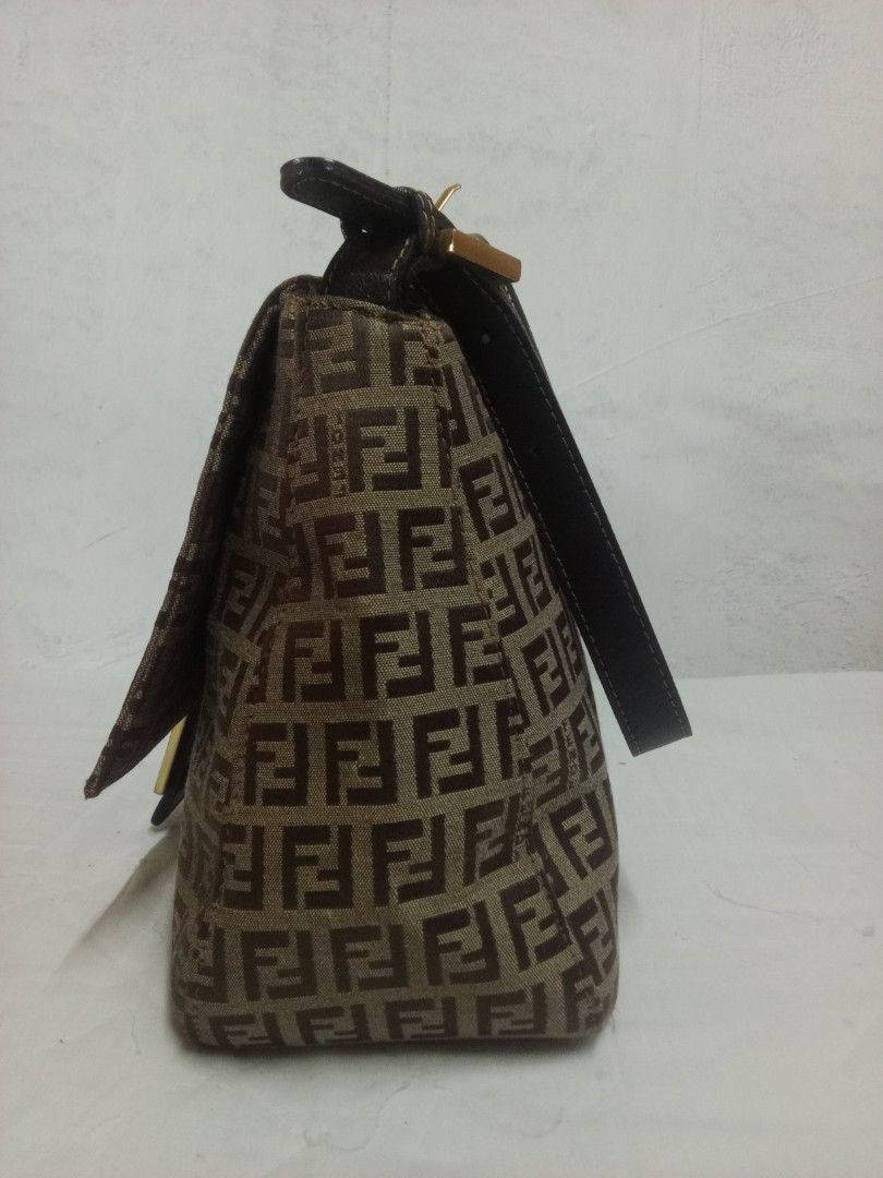 Fendi Shoulder Bag (Category: Luxury Bags & Wallets) located in Manila. Submitted by darleng.d228ef (Listing ID 1428120088, Image 2). Description: Fendi shoulder bag with the iconic FF logo pattern. Features a brown leather strap and a flap closure with a gold-tone buckle. The bag has a rectangular shape..