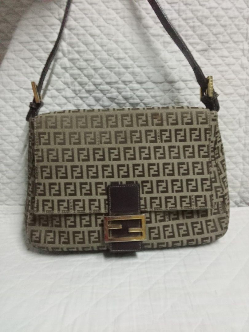 Fendi Shoulder Bag (Category: Luxury Bags & Wallets) located in Manila. Submitted by darleng.d228ef (Listing ID 1428120088, Image 1). Description: Fendi shoulder bag with the iconic FF logo pattern. Features a brown leather strap and a flap closure with a gold-tone buckle. The bag has a rectangular shape..