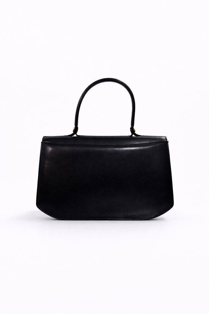 Givenchy SACS Black Handbag (Category: Luxury Bags & Wallets) located in Paranaque City. Submitted by katlouieleandicho (Listing ID 1428164636, Image 3). Description: Givenchy Black Leather 4G Top Handle Bag An elegant expression of timeless Parisian sophistication, this vintage Givenchy top handle bag is crafted from smooth black leather with a structured silhouette that exudes understated luxury. The design is elevated by a refined curved flap 