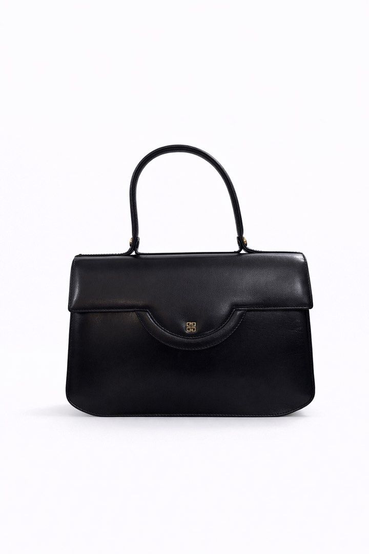 Givenchy SACS Black Handbag (Category: Luxury Bags & Wallets) located in Paranaque City. Submitted by katlouieleandicho (Listing ID 1428164636, Image 2). Description: Givenchy Black Leather 4G Top Handle Bag An elegant expression of timeless Parisian sophistication, this vintage Givenchy top handle bag is crafted from smooth black leather with a structured silhouette that exudes understated luxury. The design is elevated by a refined curved flap 