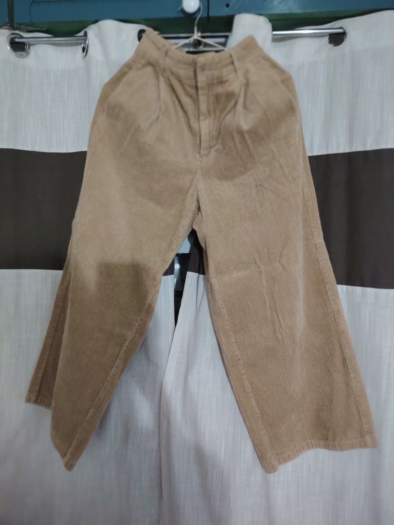 GU Corduroy Wide Leg Pants (Category: Other Bottoms) located in Quezon City. Submitted by nenggie (Listing ID 1428123255, Image 2). Description: Tan corduroy wide leg pants from GU. Features a button and zipper closure. The pants have a relaxed fit and a wide leg opening. The size tag is visible in the image. Fits waistline 26 to 28.