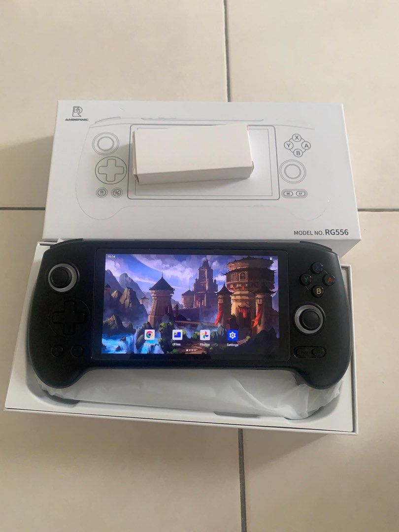 Handheld Console (Category: Others) located in Raub. Submitted by hidayat.abdaziz (Listing ID 1428169213, Image 1). Description: RG556 condition tiptop, jarang guna, semua fungsi ok. Skrin AMOLED cantik, boleh main game PS2 PSP/PS1/N64 dengan smooth. Datang sekali charger. Harga RM 500.