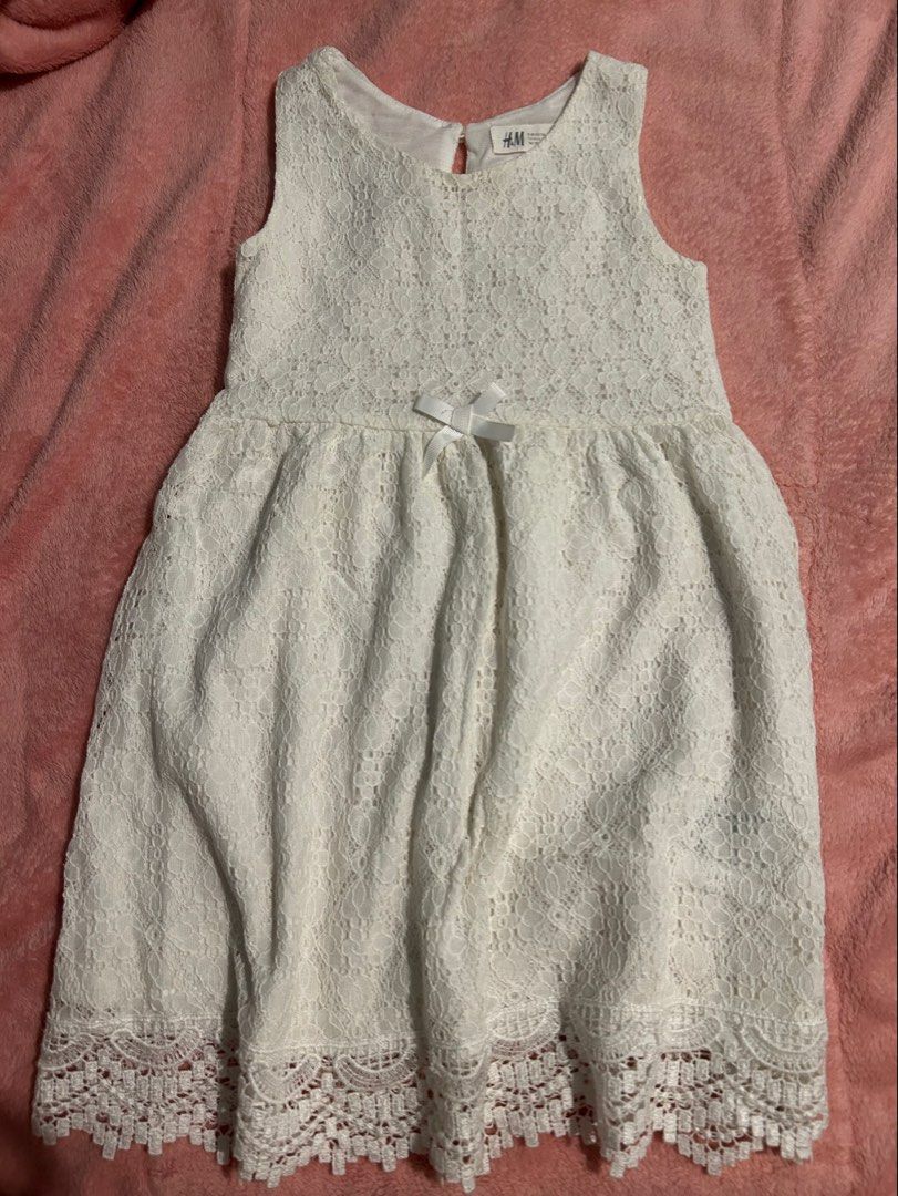 H&M White Lace Dress (Category: Babies & Kids Fashion) located in Quezon City. Submitted by goodfinds2021 (Listing ID 1411154554, Image 1). Description: - Small bow detail at the waist - Flared skirt - Delicate lace fabric 4-6on tag W 12 L24.