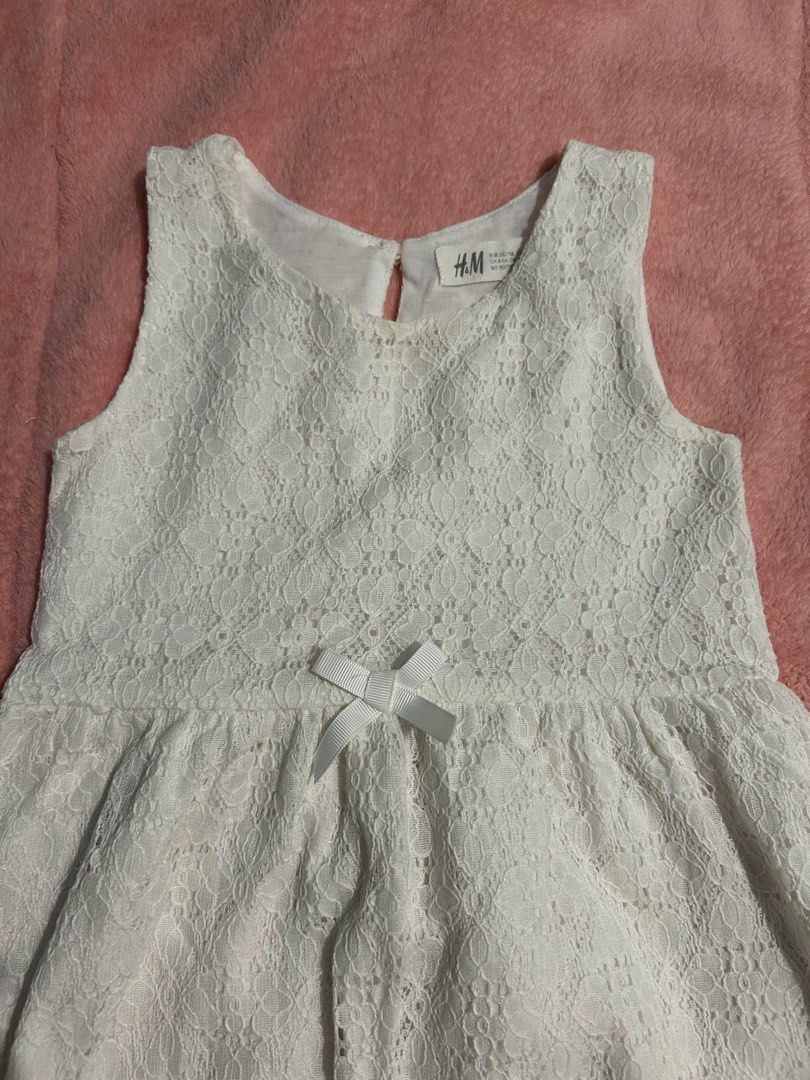 H&M White Lace Dress (Category: Babies & Kids Fashion) located in Quezon City. Submitted by goodfinds2021 (Listing ID 1411154554, Image 3). Description: - Small bow detail at the waist - Flared skirt - Delicate lace fabric 4-6on tag W 12 L24.