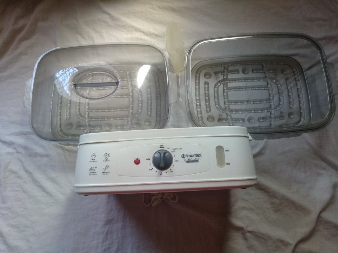 Imarflex Food Steamer (Category: Cookware & Accessories) located in Manila. Submitted by racgeb (Listing ID 1428143125, Image 3). Description: legit Imarflex food steamer features a white base with a clear, two-tiered steaming compartment. It has a timer knob and indicator lights for different cooking settings. The steamer includes a lid and two steaming trays. The model number is visible on the back. lightly used only excellent working condition