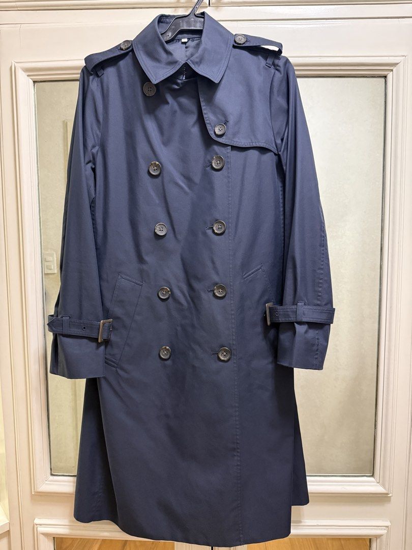 Navy Trench Coat - Size M (Category: Coats, Jackets and Outerwear) located in Quezon City. Submitted by declutter1ngmama (Listing ID 1428239429, Image 1). Description: Classic navy trench coat. Features a double-breasted design with button closures and adjustable cuffs. The coat has a tailored fit and a back vent for ease of movement. Comes with belt Used only once Size M..