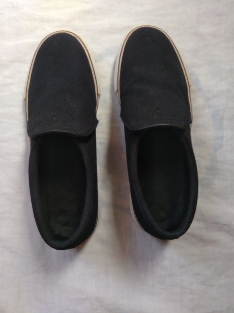 Nike Slip-On Sneakers Black (Category: Sneakers) located in Manila. Submitted by racgeb (Listing ID 1428140967, Image 2). Description: legit Black Nike slip-on sneakers. Features a white sole with a black upper. The Nike logo is visible on the side and the sole. The size is US 6.5, UK 4, EUR 37.5, and CM 23.5. The style code is BQ9138-001. Made in Indonesia.size : 9US 8UK EUR42.5 Cm27 issue : minimal yellowish on sole only rfs : need cash for my 