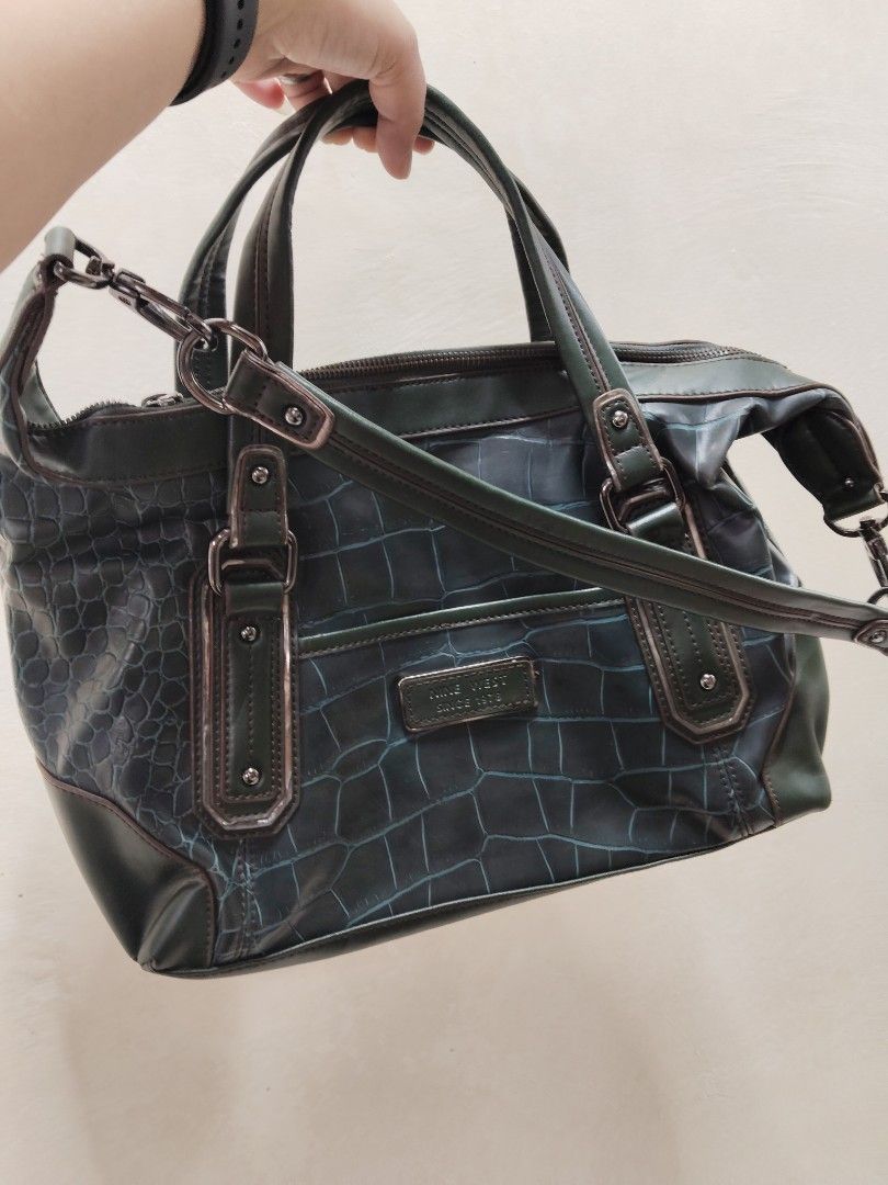 Nine West Green Crocodile Handbag (Category: Luxury Bags & Wallets) located in Batangas. Submitted by kasualcornerph (Listing ID 1428156695, Image 1). Description: Stylish Nine West handbag in a unique green crocodile pattern. Features a top handle and a detachable shoulder strap for versatile carrying options. The interior is spacious, with a branded tag. The bag has a zipper closure and includes a small pocket on the front. Made from PU materia