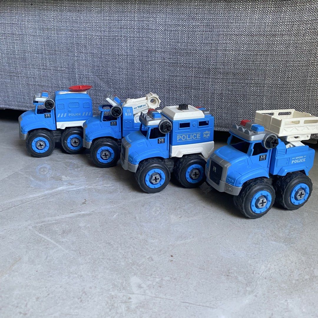 Police Toy Trucks Set (Category: Kids Toys) located in Taguig. Submitted by mixmix16 (Listing ID 1428105230, Image 1). Description: Set includes several blue police toy trucks. Each truck has large wheels and different attachments, such as a tow truck arm, a siren, and a cargo bed. The set is ideal for children who enjoy playing with toy vehicles..