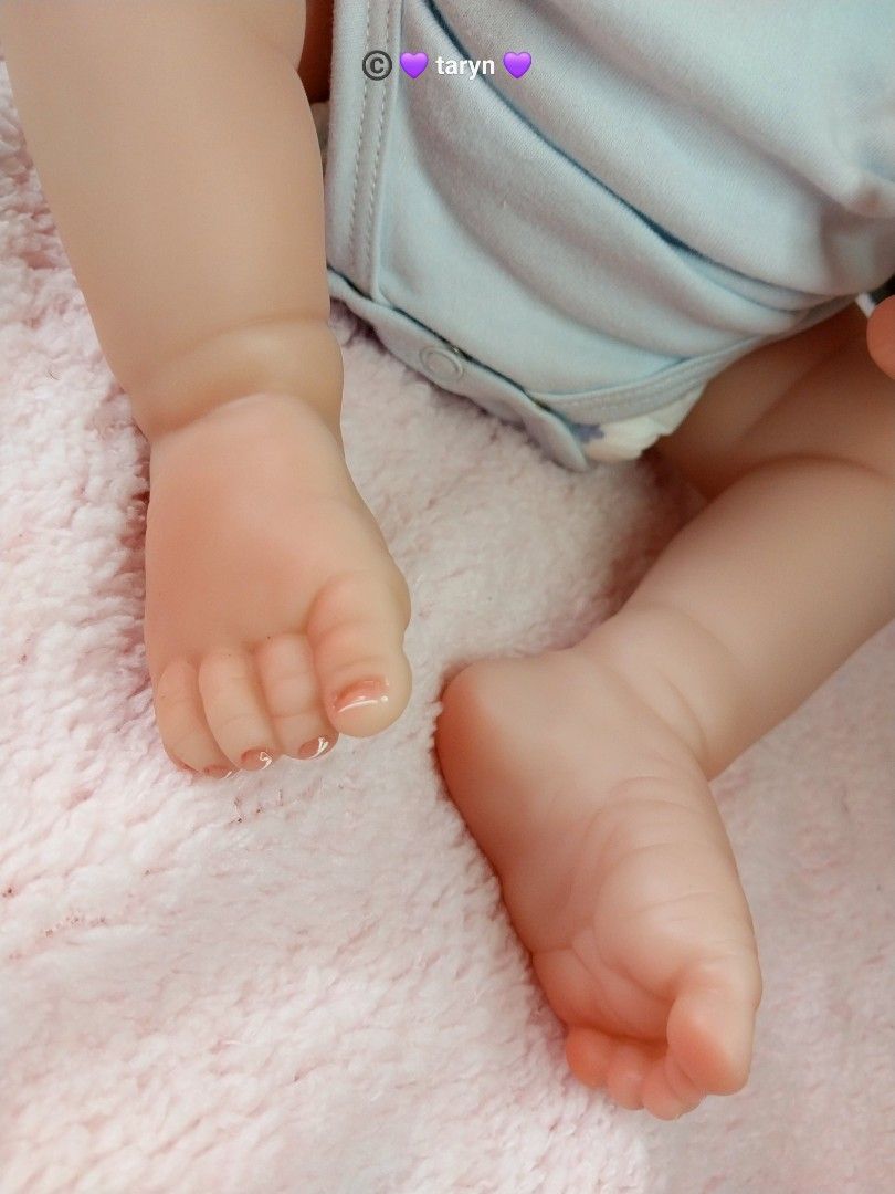 Reborn Baby Doll with Accessories (Category: Babies & Kids Fashion) located in Cebu City. Submitted by iceelily (Listing ID 1428125330, Image 3). Description: Adorable reborn baby doll with realistic features. Comes with a knitted hat, a pacifier, and a baby bottle. The doll is wearing a blue onesie. Includes a birth certificate. Perfect for collectors or as a gift. The doll has detailed hands and feet..