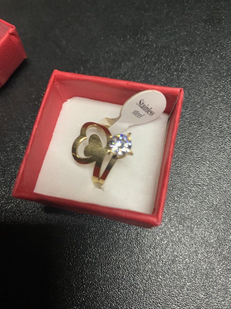 Stainless Steel Heart Ring with Diamond (Category: Rings) located in Manila. Submitted by foreverble80256 (Listing ID 1428117109, Image 3). Description: Elegant stainless steel ring featuring a heart design and a sparkling diamond. It comes in a red box, perfect for gifting or personal use. The ring size is 17. The ring is gold in color. Made of stainless steel..