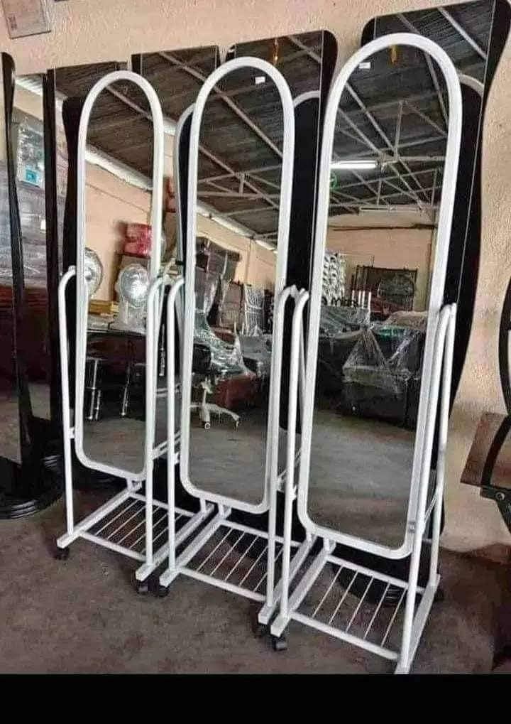 Standing Full Body Mirror with Rack (Category: Mirrors) located in Quezon City. Submitted by diannecaya86853 (Listing ID 1428253794, Image 1). Description: Full-length standing mirror with a metal frame and a built-in rack. Available in black and white frame colors. The mirror has a curved top design and is mounted on a wheeled base for easy movement. Suitable for bedrooms, dressing rooms, or any space needing a full-body mirror..