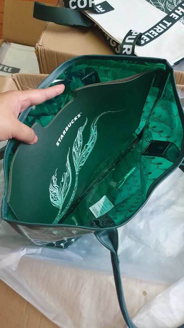 Starbucks Jelly Tote Bag (Category: Tote Bags) located in San Juan City. Submitted by leyuri_shop2025 (Listing ID 1428200334, Image 3). Description: From Starbucks China Exclusives Dragon Boat Festival 2025 Series. The tote bag features a unique mermaid tail design. It includes a detachable inner pouch. The bag has a transparent exterior with a green scale pattern. It has sturdy handles for easy carrying. The bag is perfect for everyday use..