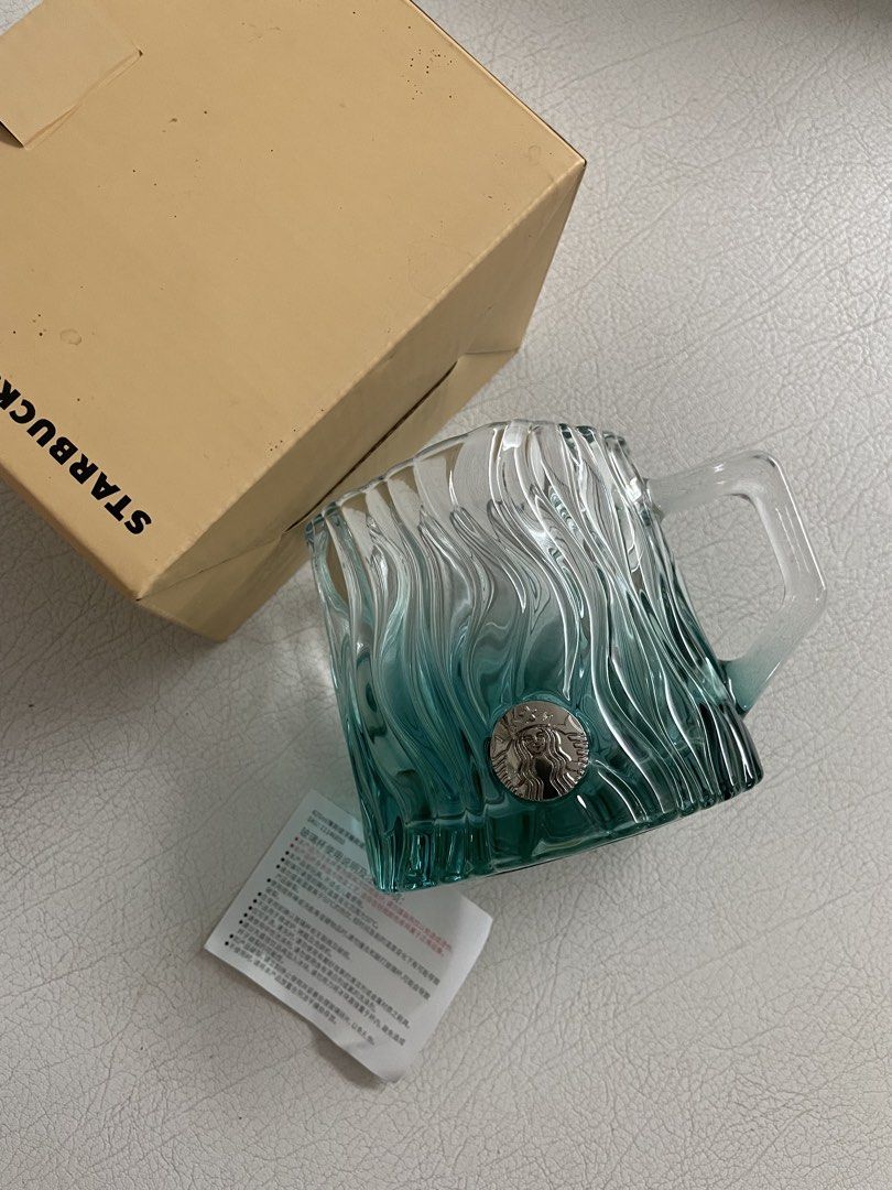 Starbucks Water Relief Glass mug (Category: Home Improvement Tools & Accessories) located in Davao. Submitted by goldcarp (Listing ID 1428097445, Image 1). Description: For sale: Starbucks China Summer Mint Green Water Ripple Relief Glass Mug RARE! Condition: Brand New Authentic. Complete set w box. Description: This hard to find mug features a textured, ripple-like design in a mint green and clear gradient finish with a silver Starbucks Siren lo