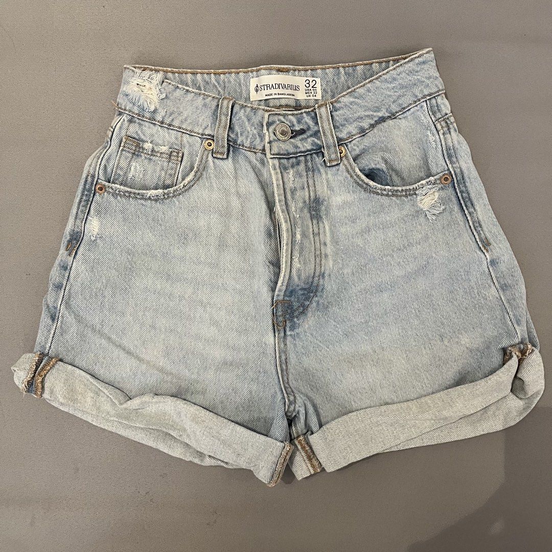 Stradivarius Denim Shorts Size 24 (Category: Shorts) located in Manila. Submitted by amiahkm (Listing ID 1428118338, Image 1). Description: Light wash denim shorts from Stradivarius. Features a high-waisted design with distressed details. Includes classic five-pocket styling and a button closure. The shorts have rolled-up cuffs. Size 32..