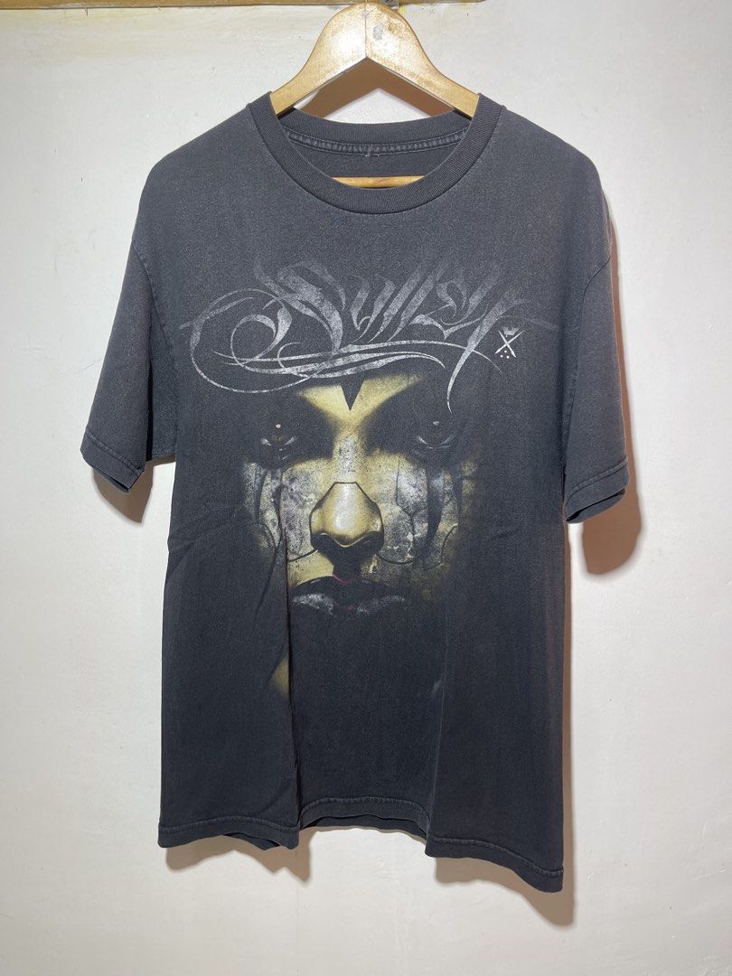 Swollen Art Collective Graphic Tee y2k (Category: Tshirts & Polo Shirts ) located in Bulacan. Submitted by archivesgallery_ (Listing ID 1428165430, Image 1). Description: Size large 22 pit to pit 30 neck to hem Minor fading Graphic tee features a striking face design on the front and back, with the words "Jak Connolly" printed on the back. It is a large size and made by Swollen Art Collective. The shirt has a crew neck and short sleeves. The shir
