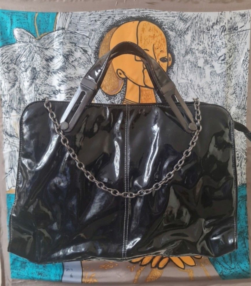 Ted Baker Black Patent Handbag (Category: Luxury Bags & Wallets) located in Quezon City. Submitted by thriftypieces (Listing ID 1428098863, Image 1). Description: preloved Ted Baker Patent bag ❤️can be used as a laptop bag (can easily fit 13" laptop or tablet) ❤️ Beautiful patent leather with unique buckle design and chain ❤️ has many compartments inside including zipper compartment ❤️ has tags inside ❤️ price is negotiable ❤️more pics upon reque