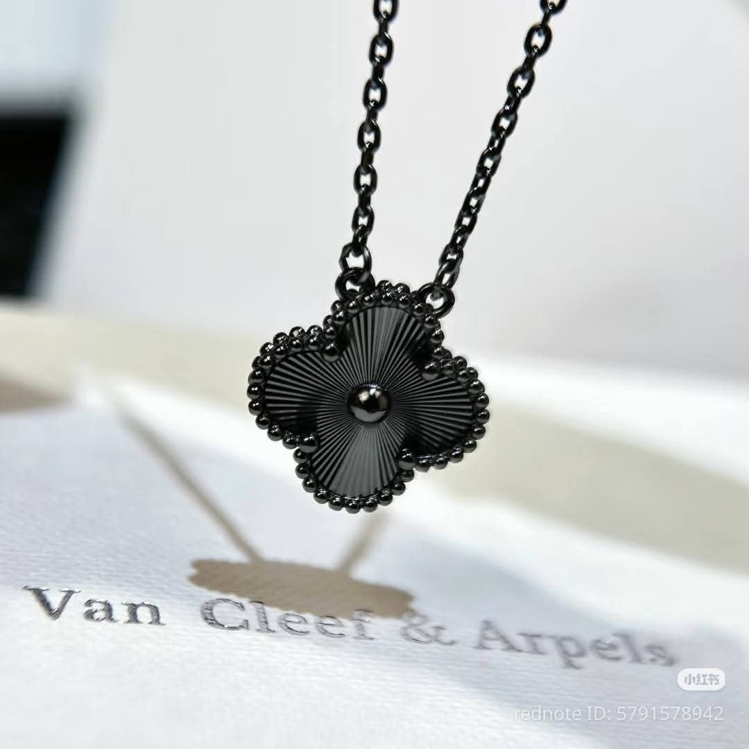 Van Cleef & Arpels Alhambra Necklace (Category: Luxury Accessories) located in Manila. Submitted by celstainlessjewelry (Listing ID 1428187139, Image 3). Description: Authentic Van Cleef & Arpels Alhambra necklace. Features a clover pendant. Comes with the original box and certificate of authenticity. The necklace is black and has a delicate chain. The pendant has a detailed design. A matching bracelet is also shown in one of the images..