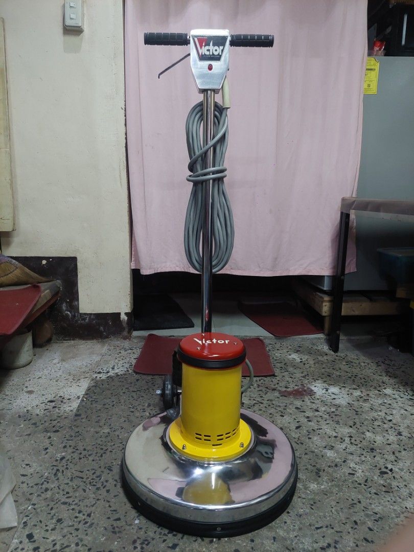 Victor Floor Polisher (Category: Construction Tools & Equipment) located in Manila. Submitted by ghelzkie (Listing ID 1428251848, Image 2). Description: Victor floor polisher with a yellow and red motor housing. It has a large, circular polishing head and a long handle for easy maneuverability. The power cord is gray. The polisher has wheels for easy movement. The brand name "Victor" is visible on the motor housing and handle..