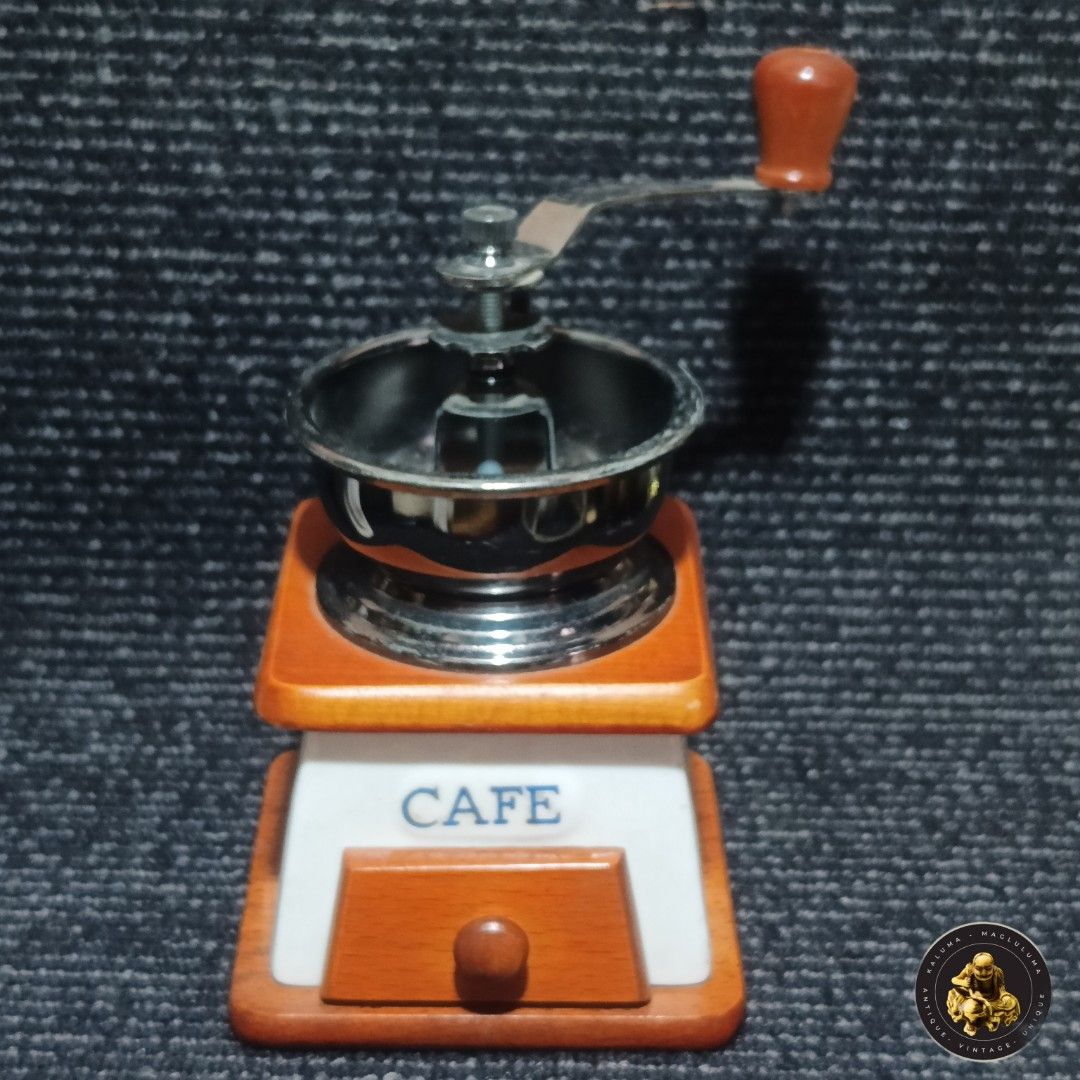 Vintage Wooden Coffee Grinder (Category: Coffee & Tea Tableware) located in Meycauayan. Submitted by ka_luma (Listing ID 1428140496, Image 1). Description: Shipping - Flash Express| Lalamove Payment - Gcash | Bank Transfer [S1-R3] Vintage coffee grinder features a wooden base and a metal grinding mechanism. It has a drawer for collecting ground coffee and a hand crank with a wooden handle. The grinder has a white front panel with the word "CAFE" 