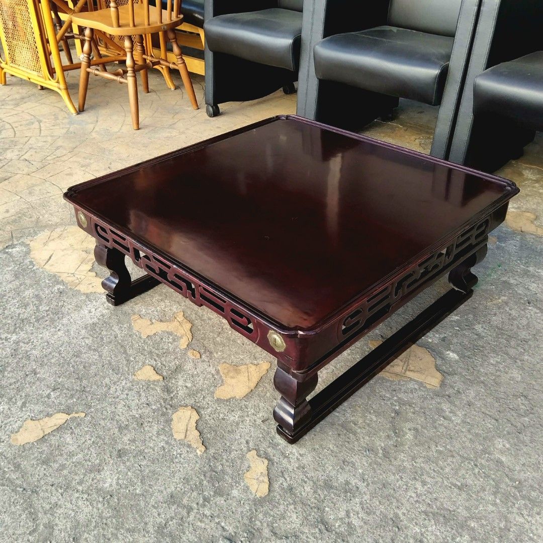 2nd hand Vintage Solid Wood Coffee Table | Foldable Legs (Category: Tables & Sets) located in Paranaque City. Submitted by 2ndcharmfurniture (Listing ID 1428329769, Image 3). Description: Elegant wooden coffee table with a rich, dark finish. Features intricate carved details along the sides and decorative brass accents. The table has a square shape and sturdy legs. Dimensions are L76cm x W75cm x H30cm. Perfect for living rooms or lounges..