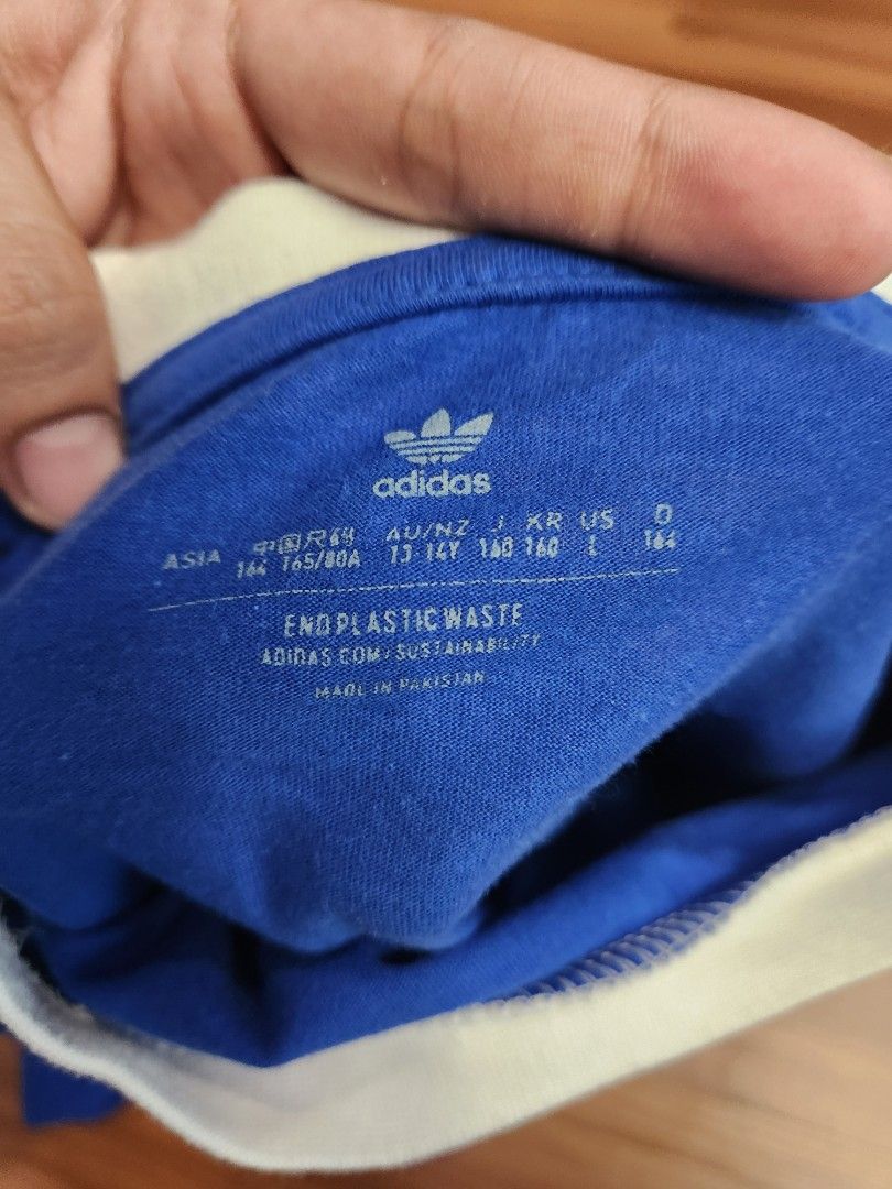 Adidas 3-stripes tee (kids) - Blue (Category: Tshirts & Polo Shirts ) located in Malabon City. Submitted by silverrust12 (Listing ID 1428288848, Image 3). Description: Adidas 3-stripes tee in Blue (for kids) Size on tag - L (kids) Pit-to-pit - 49 cm Length - 64 cm Will be washed and will send more pics upon reservation NCR area Can do meet-ups around SM North or anywhere near LRT stations Can do delivery thru Grab/Lalamove (delivery fee shouldere