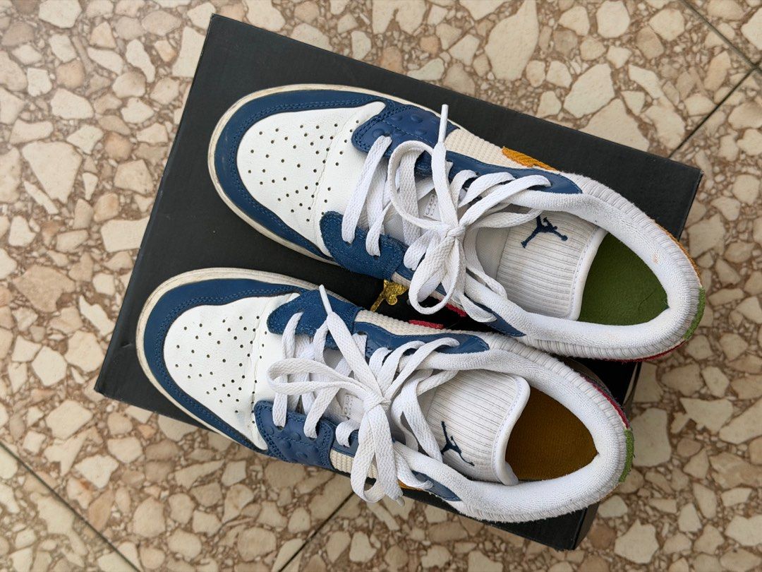 ORIGINAL Air Jordan 1 Low SE (GS) (Category: Sneakers) located in Silang. Submitted by abcdenz (Listing ID 1428299461, Image 3). Description: Air Jordan 1 Low SE (GS) in French Blue/Chutney/White colorway. Features a mix of materials and textures, including leather and textile panels. The shoes have a white base with blue and yellow accents. Comes with the original box. Size is 5.5Y..