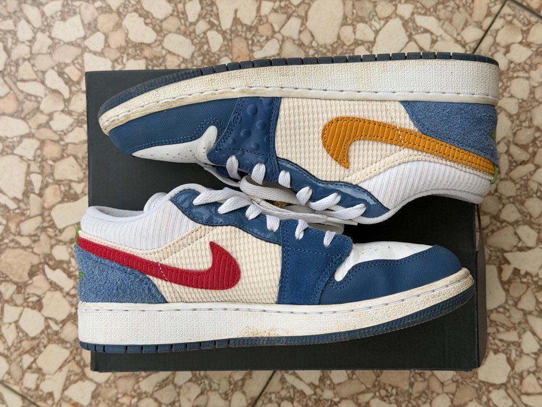 ORIGINAL Air Jordan 1 Low SE (GS) (Category: Sneakers) located in Silang. Submitted by abcdenz (Listing ID 1428299461, Image 2). Description: Air Jordan 1 Low SE (GS) in French Blue/Chutney/White colorway. Features a mix of materials and textures, including leather and textile panels. The shoes have a white base with blue and yellow accents. Comes with the original box. Size is 5.5Y..