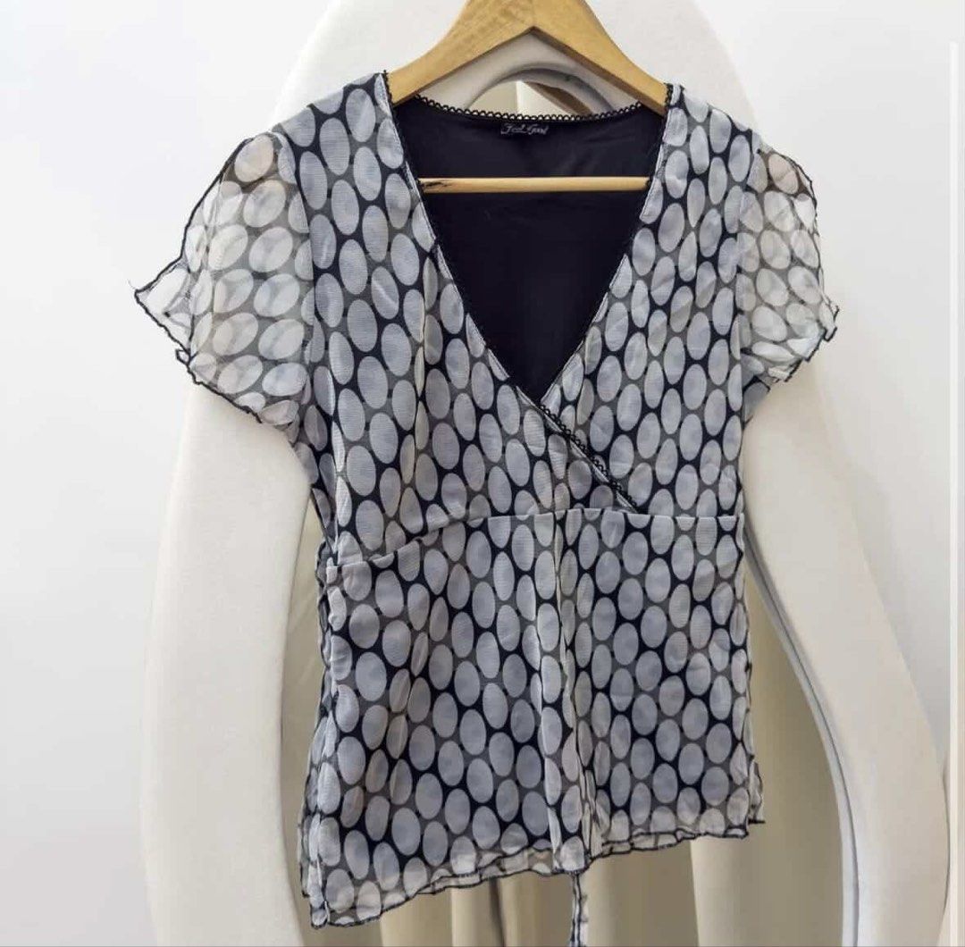 Black and white polka dot top with ties (Category: Blouses) located in Mandaluyong City. Submitted by cskrt.ph (Listing ID 1428365820, Image 1). Description: can be tied at the back for a tighter fit stretch fabric double lining! very flattering rfs: decluttering fits S-M.