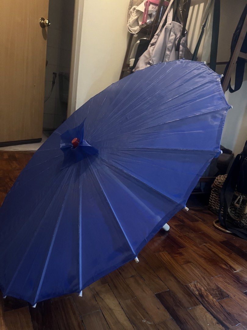 Blue Parasol Umbrella (Category: Umbrellas) located in Quezon City. Submitted by jillylilly (Listing ID 1428359008, Image 3). Description: Blue decorative umbrella. It has a white handle. The umbrella has a classic design with a pleated fabric. Perfect for photoshoots or as a unique decor piece..