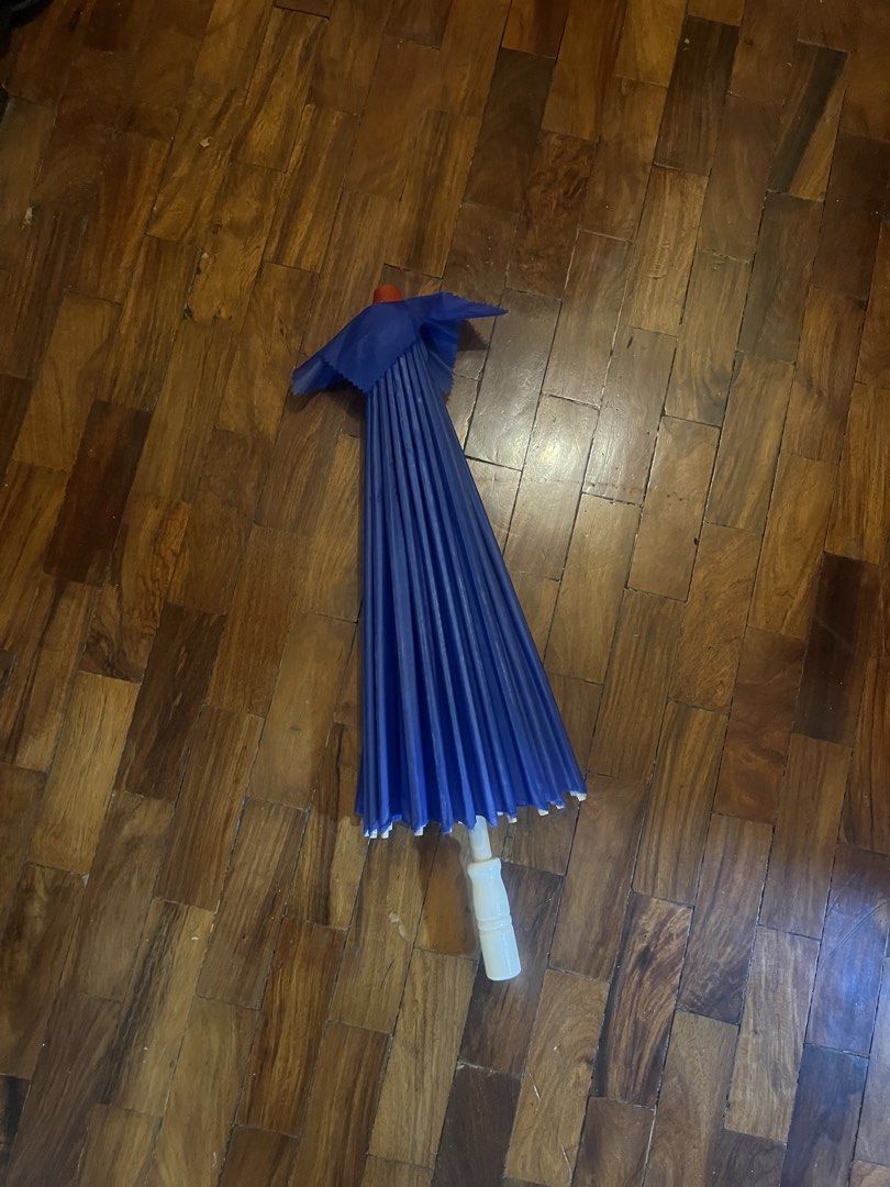 Blue Parasol Umbrella (Category: Umbrellas) located in Quezon City. Submitted by jillylilly (Listing ID 1428359008, Image 1). Description: Blue decorative umbrella. It has a white handle. The umbrella has a classic design with a pleated fabric. Perfect for photoshoots or as a unique decor piece..