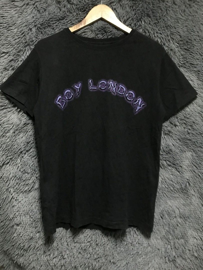 Boy London Black T-shirt (Category: Tshirts & Polo Shirts ) located in Manila. Submitted by thrift_marvs (Listing ID 1428416637, Image 1). Description: Black Boy London T-shirt with a skull and wings design on the back. Features the Boy London logo on the front. The shirt has a crew neck and short sleeves. The tag is visible, confirming the brand. The design on the back includes a skull with wings and a chain..