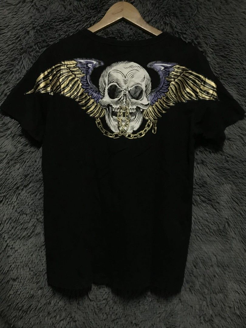 Boy London Black T-shirt (Category: Tshirts & Polo Shirts ) located in Manila. Submitted by thrift_marvs (Listing ID 1428416637, Image 3). Description: Black Boy London T-shirt with a skull and wings design on the back. Features the Boy London logo on the front. The shirt has a crew neck and short sleeves. The tag is visible, confirming the brand. The design on the back includes a skull with wings and a chain..