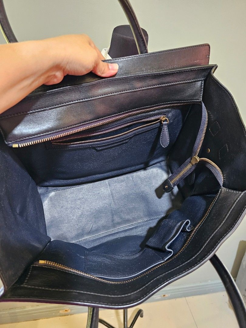 💯AUTH Celine Black Leather Handbag (Category: Luxury Bags & Wallets) located in Cagayan de Oro. Submitted by hotpink26 (Listing ID 1428424424, Image 3). Description: Black leather handbag with gold-toned hardware. Features a top zipper closure and multiple interior compartments. Includes double top handles and a front exterior zipper pocket. The Celine logo is visible on the front of the bag..