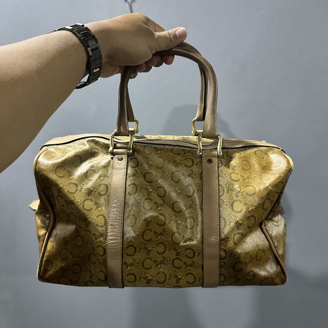 Celine Boston Bag (Category: Luxury Bags & Wallets) located in Mangaldan. Submitted by restyle.fitv2 (Listing ID 1428264268, Image 1). Description: Authentic Celine Boston bag featuring the iconic 'C' logo print. It has a zip closure and dual top handles. The bag has a tan leather trim and gold-tone hardware. The zipper pull has a Celine logo charm. 100% authentic Rank B.
