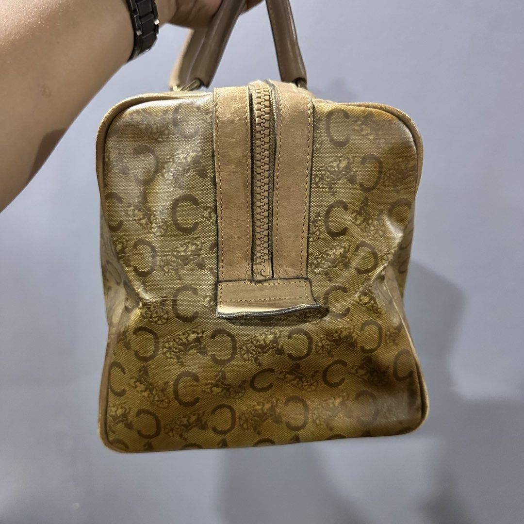 Celine Boston Bag (Category: Luxury Bags & Wallets) located in Mangaldan. Submitted by restyle.fitv2 (Listing ID 1428264268, Image 2). Description: Authentic Celine Boston bag featuring the iconic 'C' logo print. It has a zip closure and dual top handles. The bag has a tan leather trim and gold-tone hardware. The zipper pull has a Celine logo charm. 100% authentic Rank B.