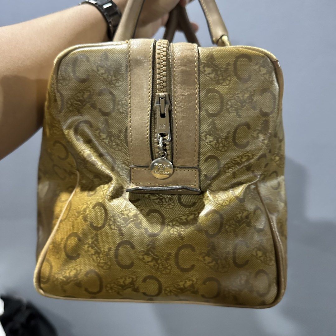 Celine Boston Bag (Category: Luxury Bags & Wallets) located in Mangaldan. Submitted by restyle.fitv2 (Listing ID 1428264268, Image 3). Description: Authentic Celine Boston bag featuring the iconic 'C' logo print. It has a zip closure and dual top handles. The bag has a tan leather trim and gold-tone hardware. The zipper pull has a Celine logo charm. 100% authentic Rank B.