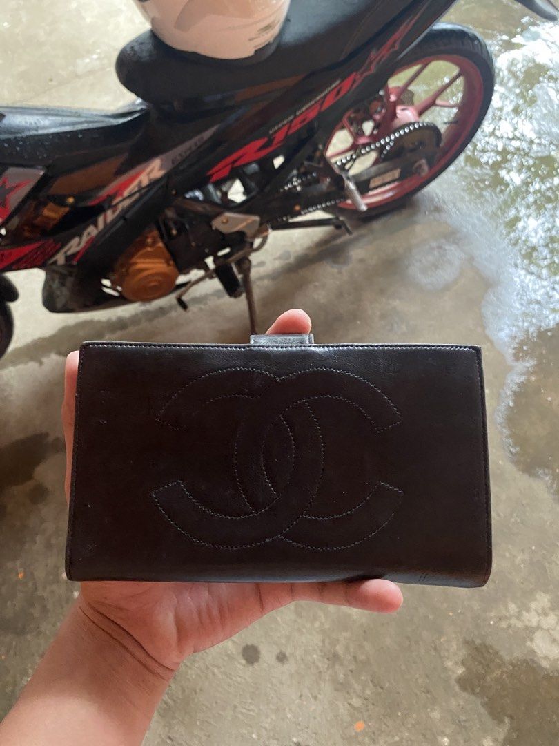 Vintage Chanel Long Wallet leather (Category: Luxury Bags & Wallets) located in Digos. Submitted by thriftnigoy (Listing ID 1428390681, Image 2). Description: Authentic Chanel long wallet. Features the iconic interlocking CC logo on the front. Made in France. The interior includes multiple card slots and compartments. The wallet has a snap closure. Serial number is visible inside the wallet. The wallet is black..