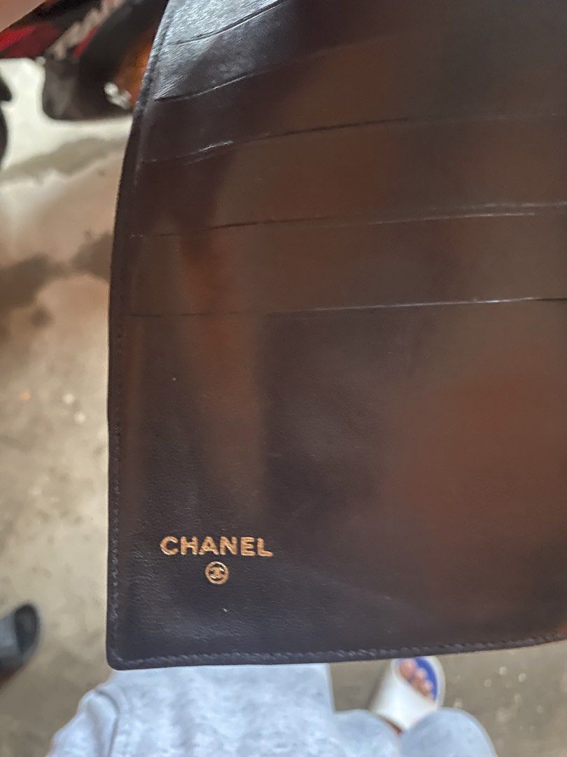 Vintage Chanel Long Wallet leather (Category: Luxury Bags & Wallets) located in Digos. Submitted by thriftnigoy (Listing ID 1428390681, Image 3). Description: Authentic Chanel long wallet. Features the iconic interlocking CC logo on the front. Made in France. The interior includes multiple card slots and compartments. The wallet has a snap closure. Serial number is visible inside the wallet. The wallet is black..