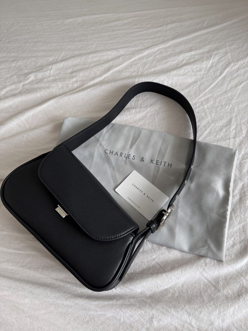 Charles & Keith Petra Asymmetrical Bag Black (Category: Shoulder Bags) located in Quezon City. Submitted by dreamhues (Listing ID 1428280629, Image 3). Description: Charles & Keith Petra Asymmetrical Shoulder Bag → Colorway: Black → Lightly used only, no obvious flaws but may have light scratches from use → Rare design (discontinued in store & online) → Resell value goes up to 200k KRW (8k PHP).