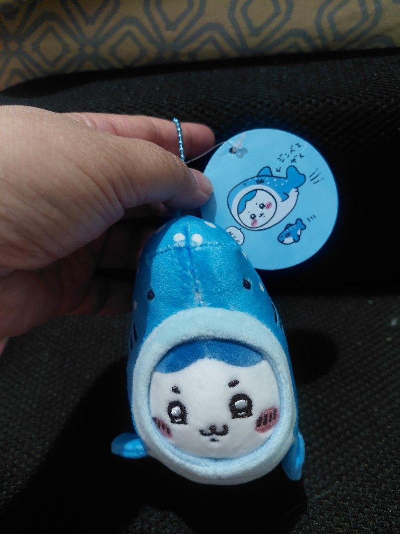 Chiikawa Whale Plushie with Tag (Category: Plushies & Soft Toys) located in Manila. Submitted by bashamylove0116 (Listing ID 1428410945, Image 1). Description: Adorable Chiikawa whale plushie. Features a blue and white design with a cute face. Comes with a matching tag. The plushie has a small loop for attaching to a keychain or bag. The tag has Japanese text and a cute illustration of the character..
