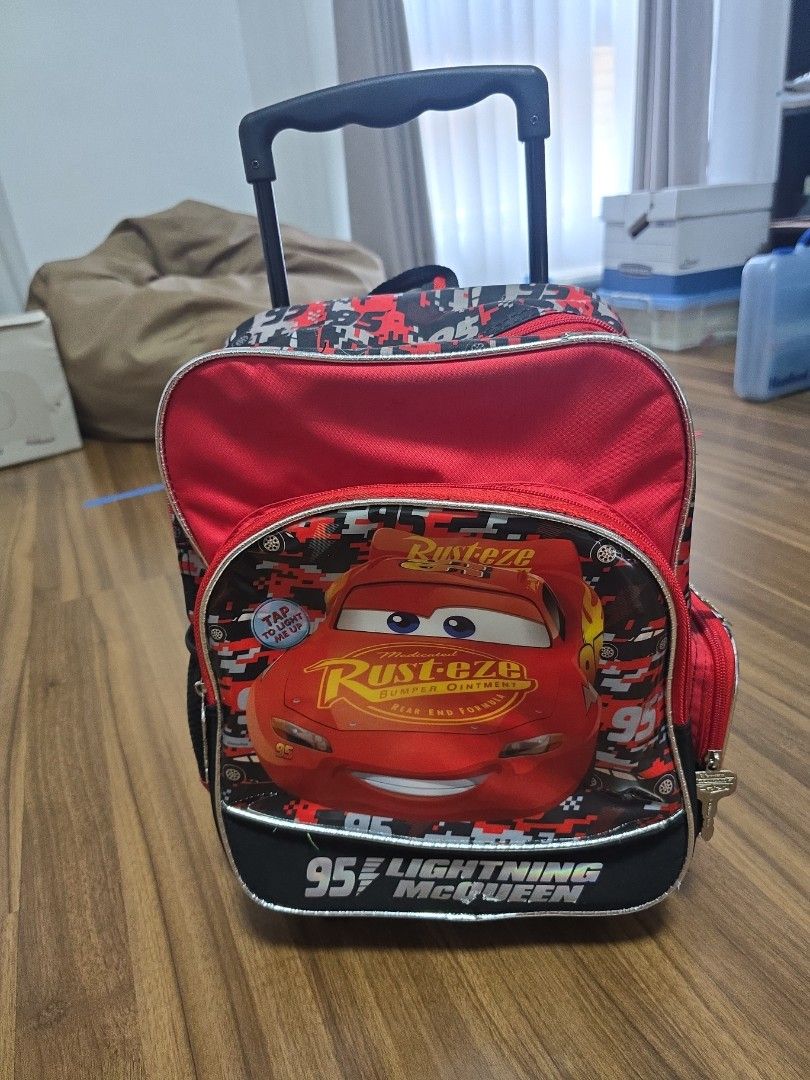 School bag Trolley - Disney Cars Lightning McQueen Rolling Backpack (Category: Babies & Kids Fashion) located in Manila. Submitted by vlllao27443 (Listing ID 1428293896, Image 1). Description: Disney Cars Bag. Used but working condition. Only sign of wear is the bottom edge as shown in the picture. Lights in the front still works. Pick up at Metrobank Rotunda, QC..